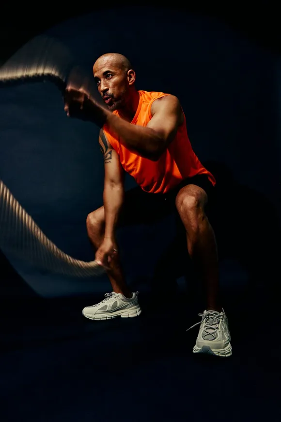A reviewer, an athlete mid-effort under hard light.